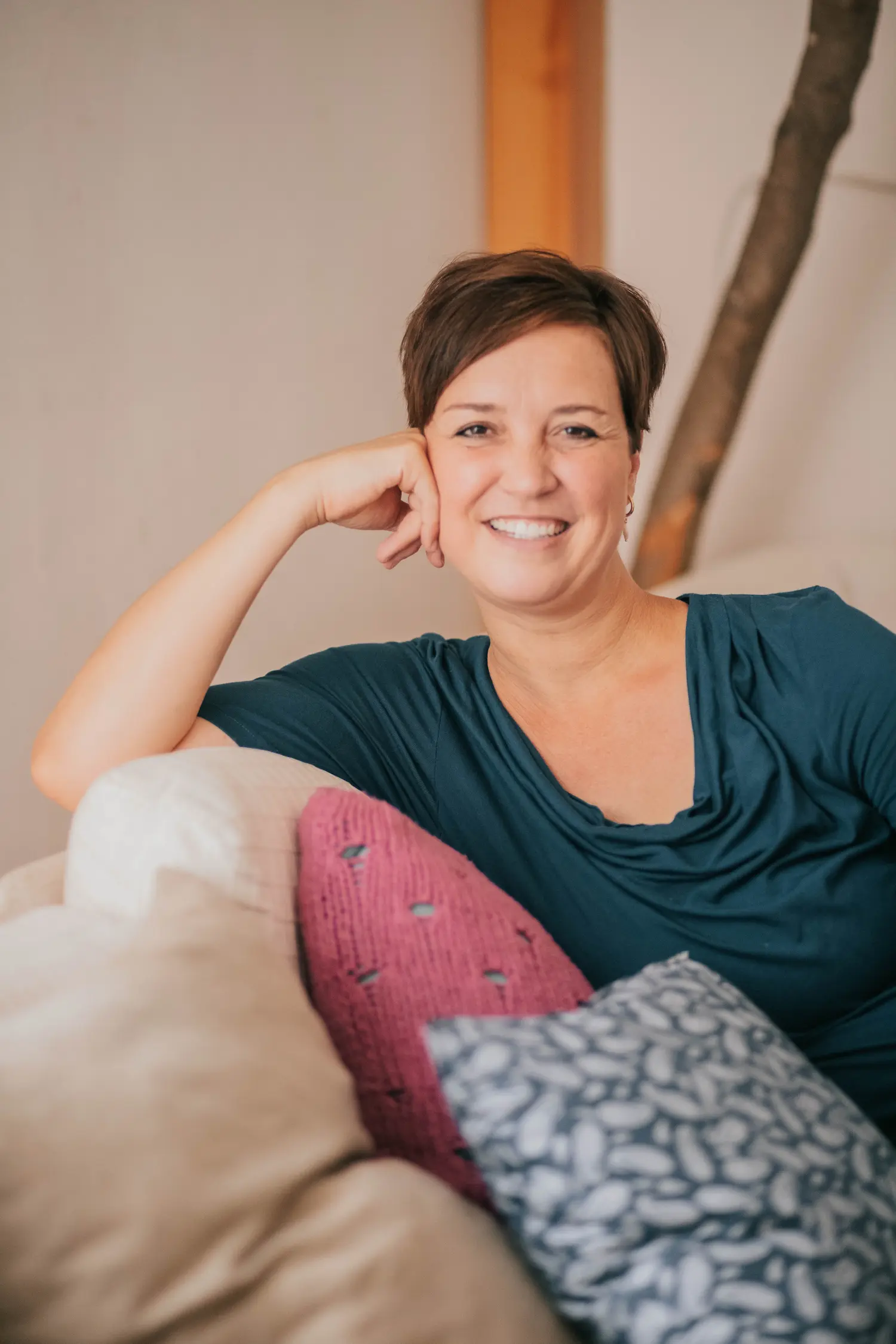 steffi sitzt lässig auf einer couch und lächelt in die kamera
